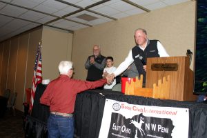 Award presented at the podium in front of the SCI East Ohio – NW Penn banner