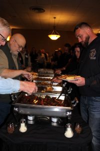 Guests filling plates at the dinner buffet