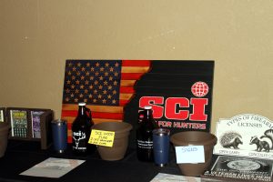 SCI-branded raffle prizes, including a wooden flag and drinkware